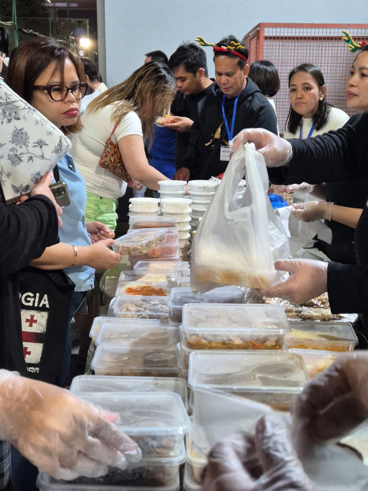 Community members receiving meals during the outreach evening