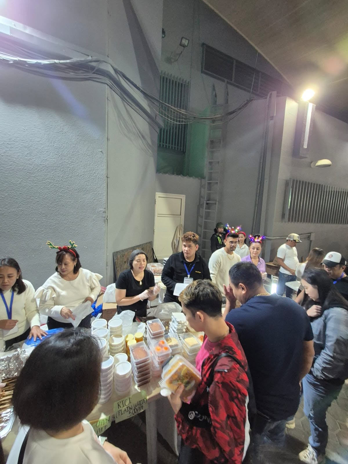 Sweet Pepper crew serving packed meals at a community Christmas outreach