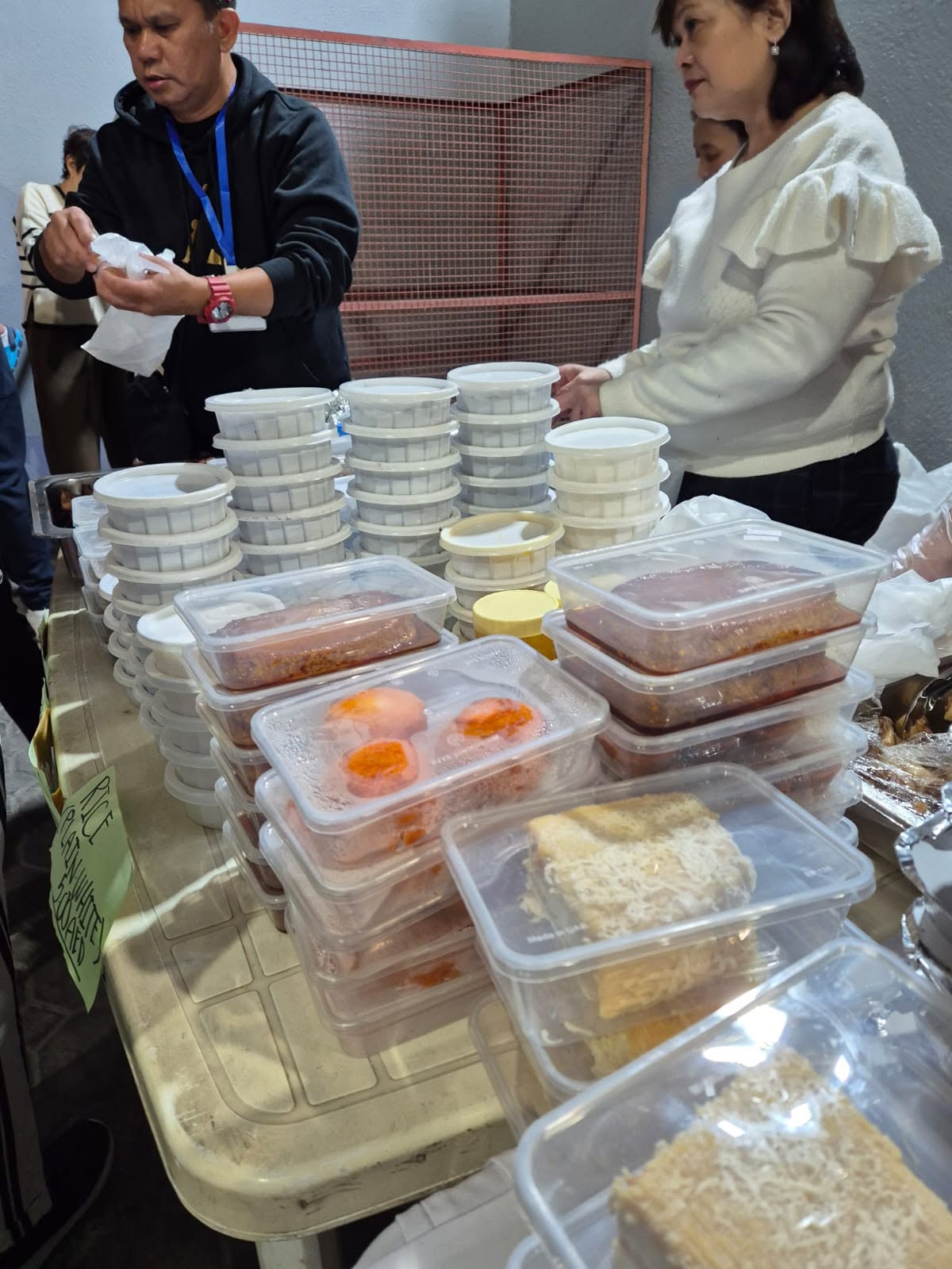Stacks of packed rice and viand containers prepared for the community